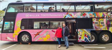 Two Tourists Beside Bus